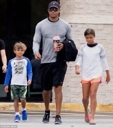 Champion on and off the course: Tiger Woods takes a break from golf and enjoys a stroll with his cubs, basking in the joy of fatherhood.