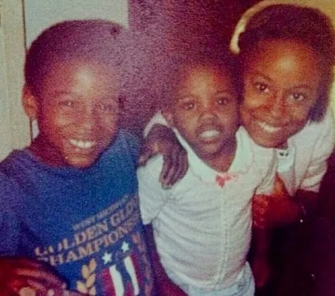 This is Floyd Mayweather as a kid. From the look of his smile, you can spot him.