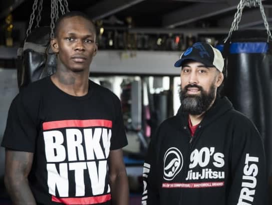 Israel Adesanya at Central Kickboxing gym where he trains with coach Eugene Bareman (left).