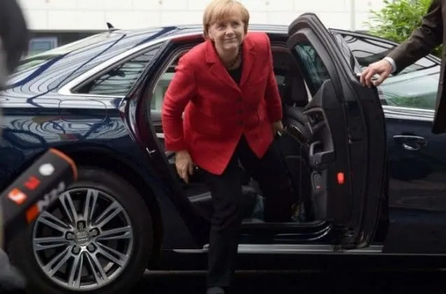 Angela Merkel stepping out of her protected Audi A8 L official vehicle.