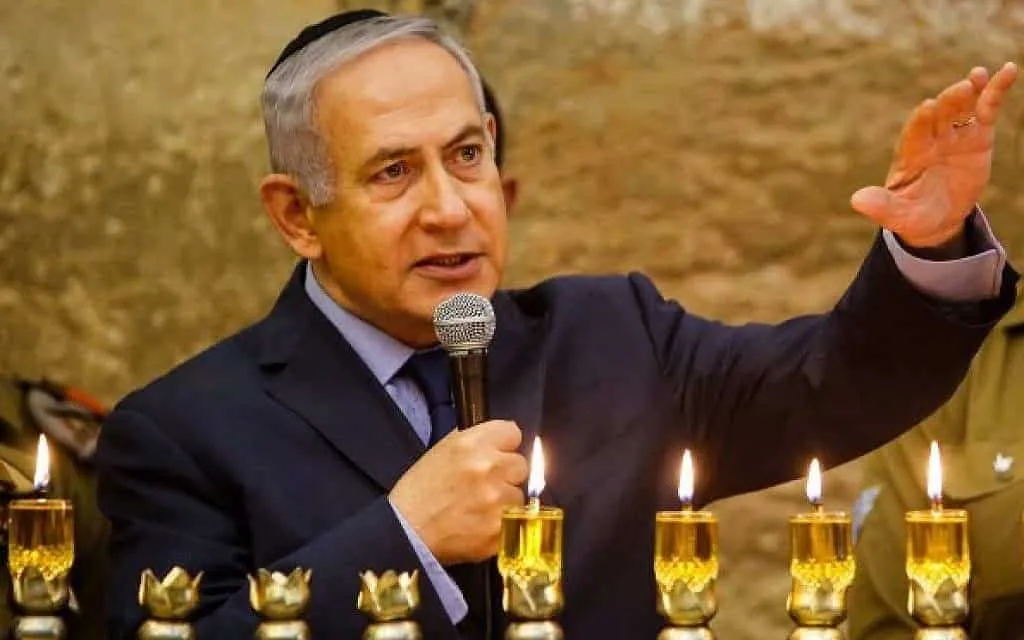 Benjamin Netanyahu speaks after lifting the candles of Hanukkah.