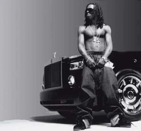 Lil Wayne posing with his Rolls Royce.