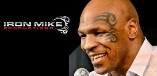 Mike Tyson besides official logo of Iron Mike Production. Can you see his facial tattoo art on the Logo?.