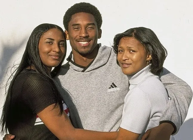 Kobe Bryant with his two older sisters Sharia (left) and Shaya (right). Oh how much they loved him!