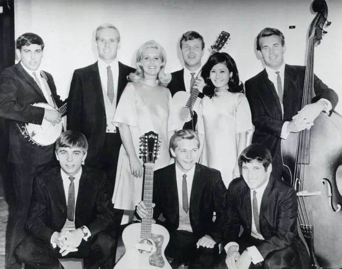 Can you spot the then music prodigy holding a stand up bass in this group photo with the Christy Minstrels?