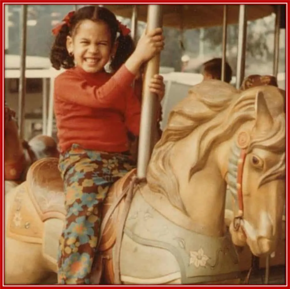 Harris rides a carousel in this old childhood photo.