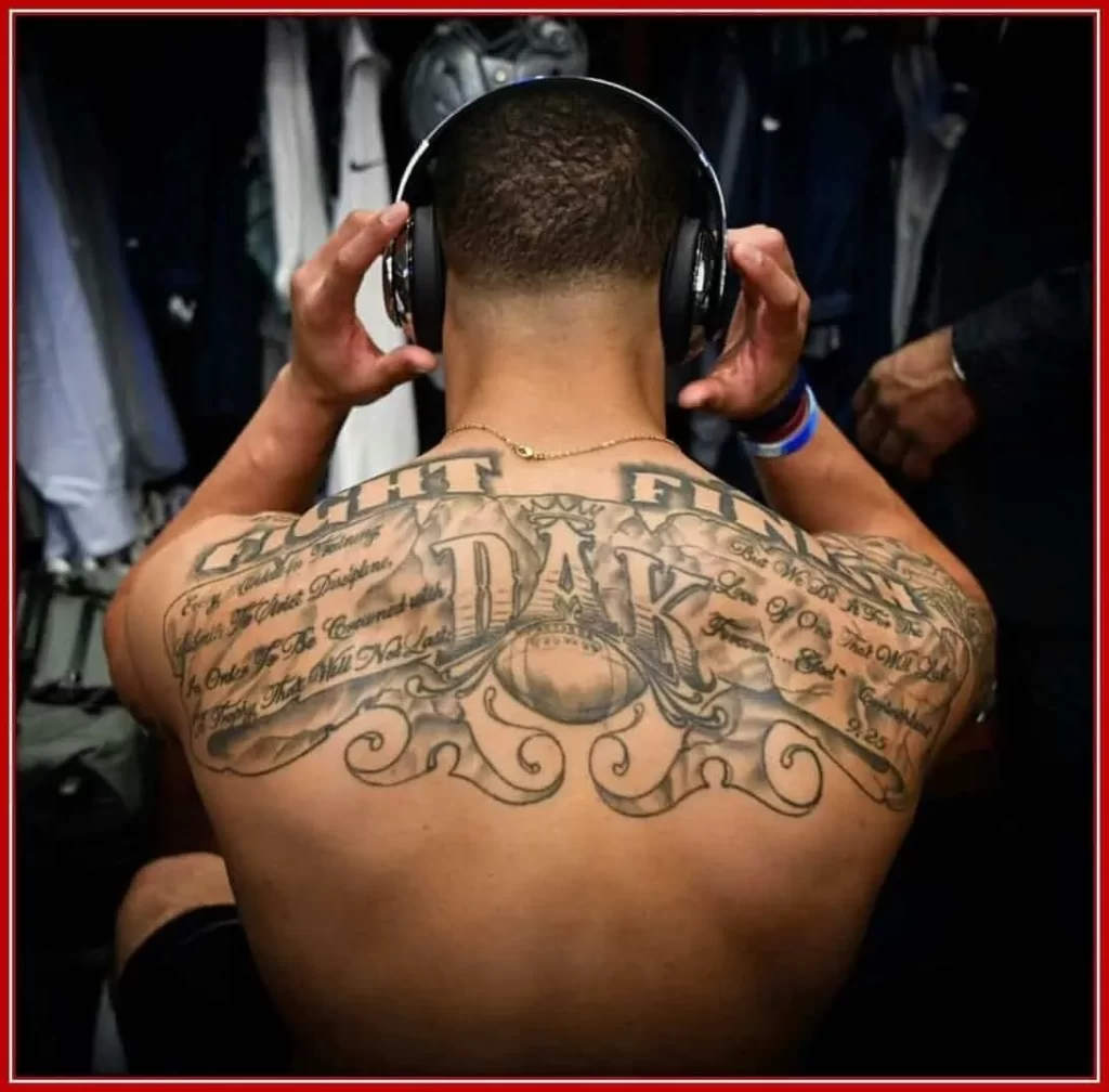His back tattoo proves his inseparable love for football.