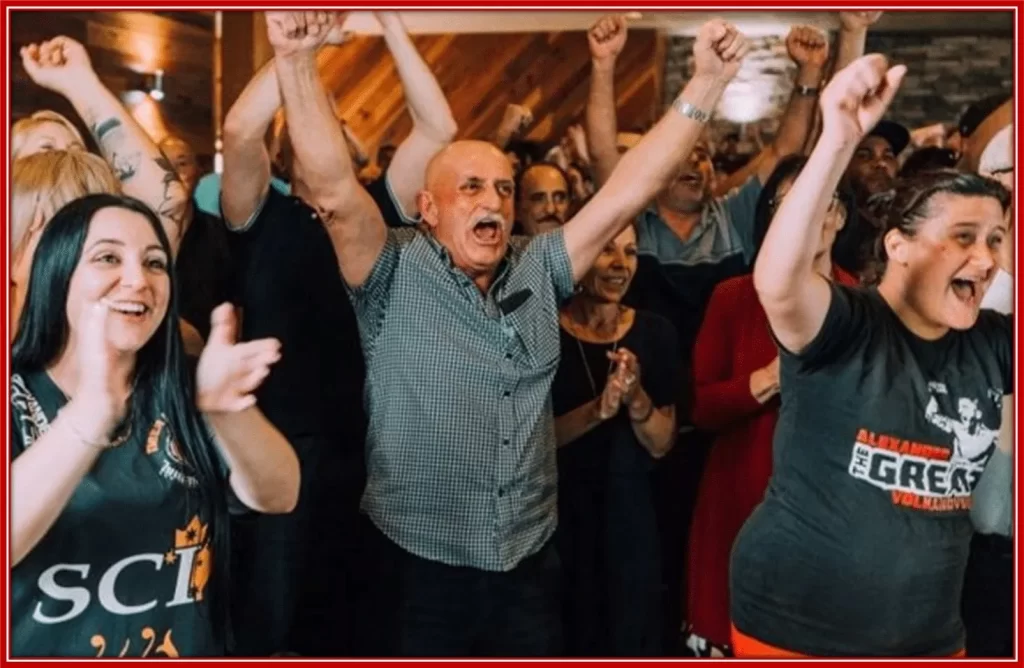 Alex's dad, Tony Volkanovski celebrating his son's victory at the local bar.