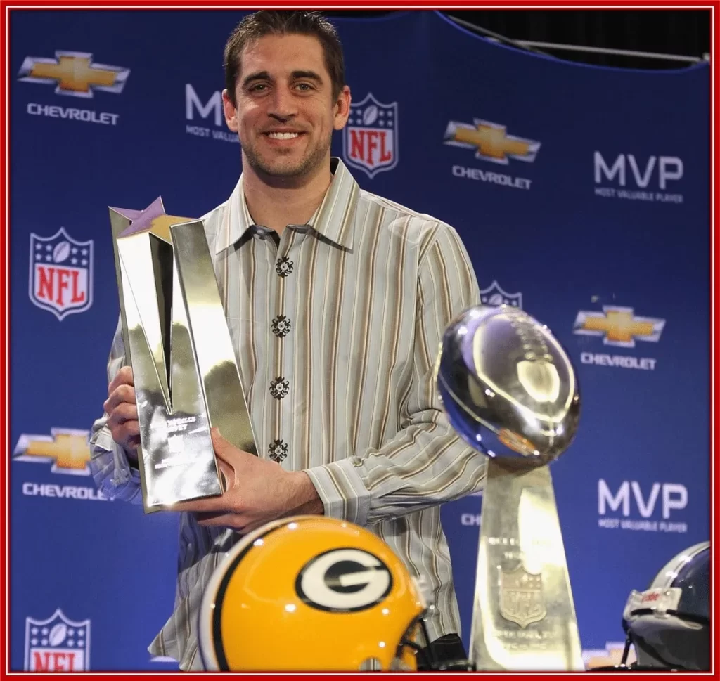 Aaron Rodgers posing with Super Bowl MVPs Trophy in 2011.
