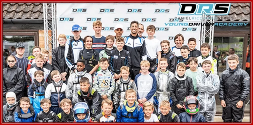 A photo with students at the Daniel Ricciardo Young Driver Academy.