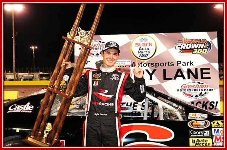The Young NASCAR K $N pro-Series Winner 2012 is Holding his Huge Trophy.