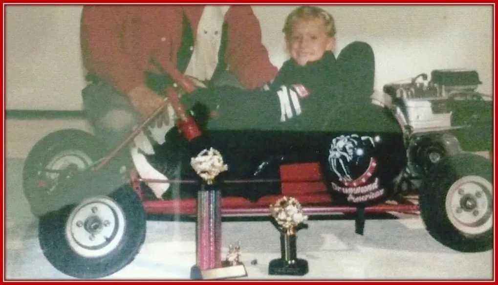 Brad Keselowski, With his First Go-Kart, Smiling Proudly at the Camera.