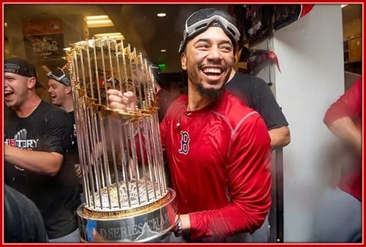 The Laughter on Mookie Betts' Face Shows how Happy the World Series Champion is Holding his Trophy.