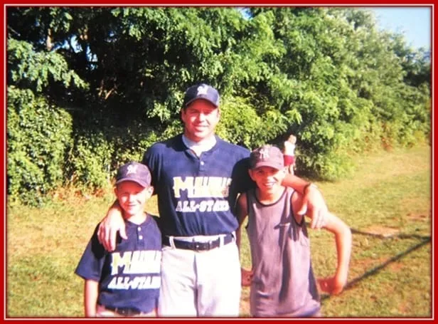 Jeff Trout, With his two sons Standing Beside him in his Baseball Games.