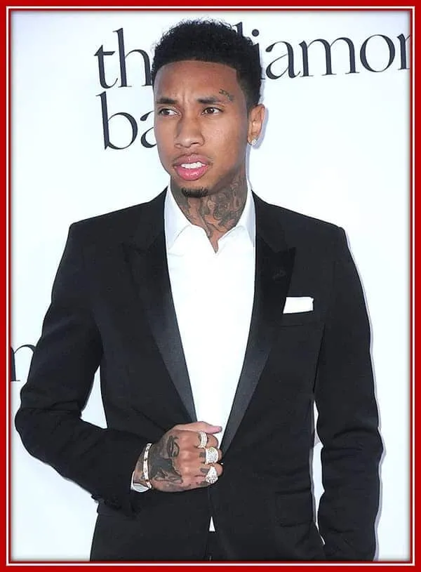 Behold the Rapper Tyga, Looking Glamorous in his Attire as he Poses for the Camera.