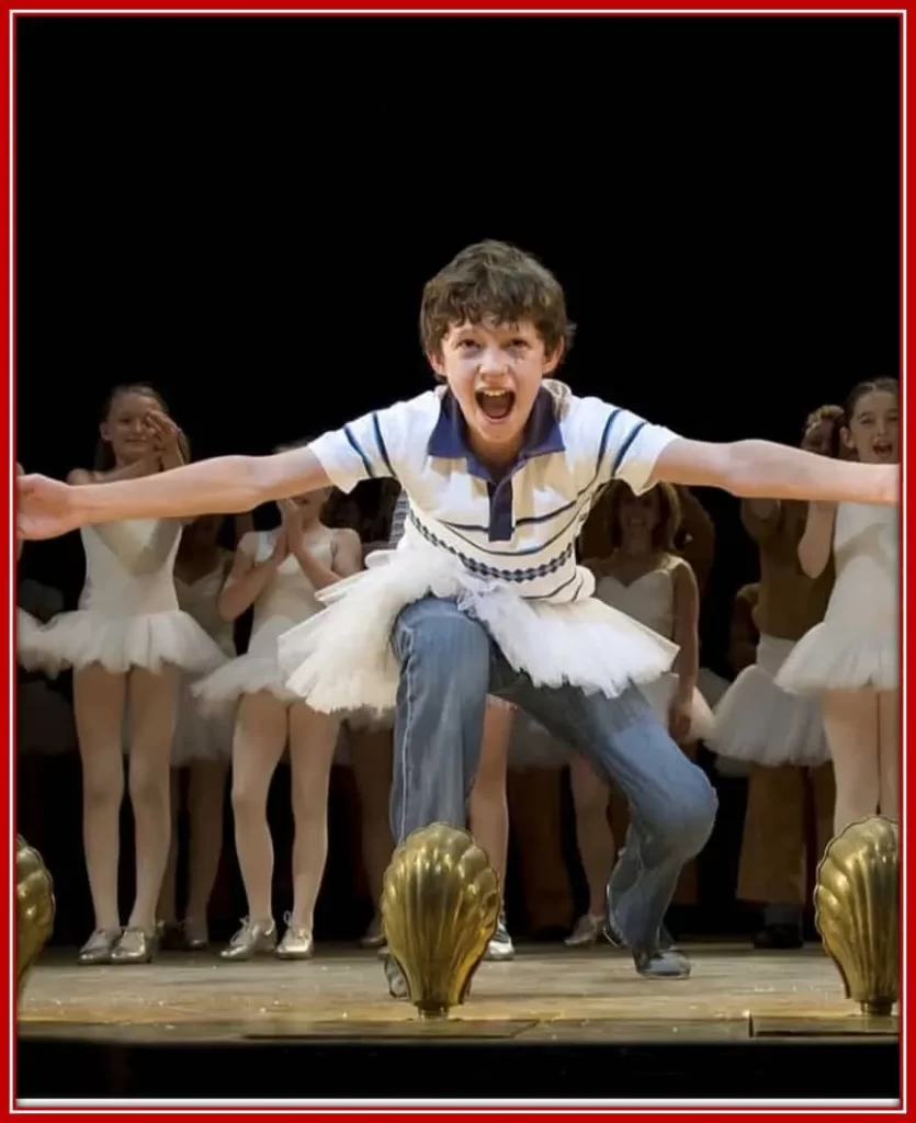 Photo of Tom dancing with his crew in the musical video Billy Elliot