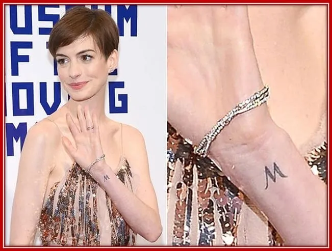 See Anne Hathaway's Tiny M Tattoo on her Wrist.