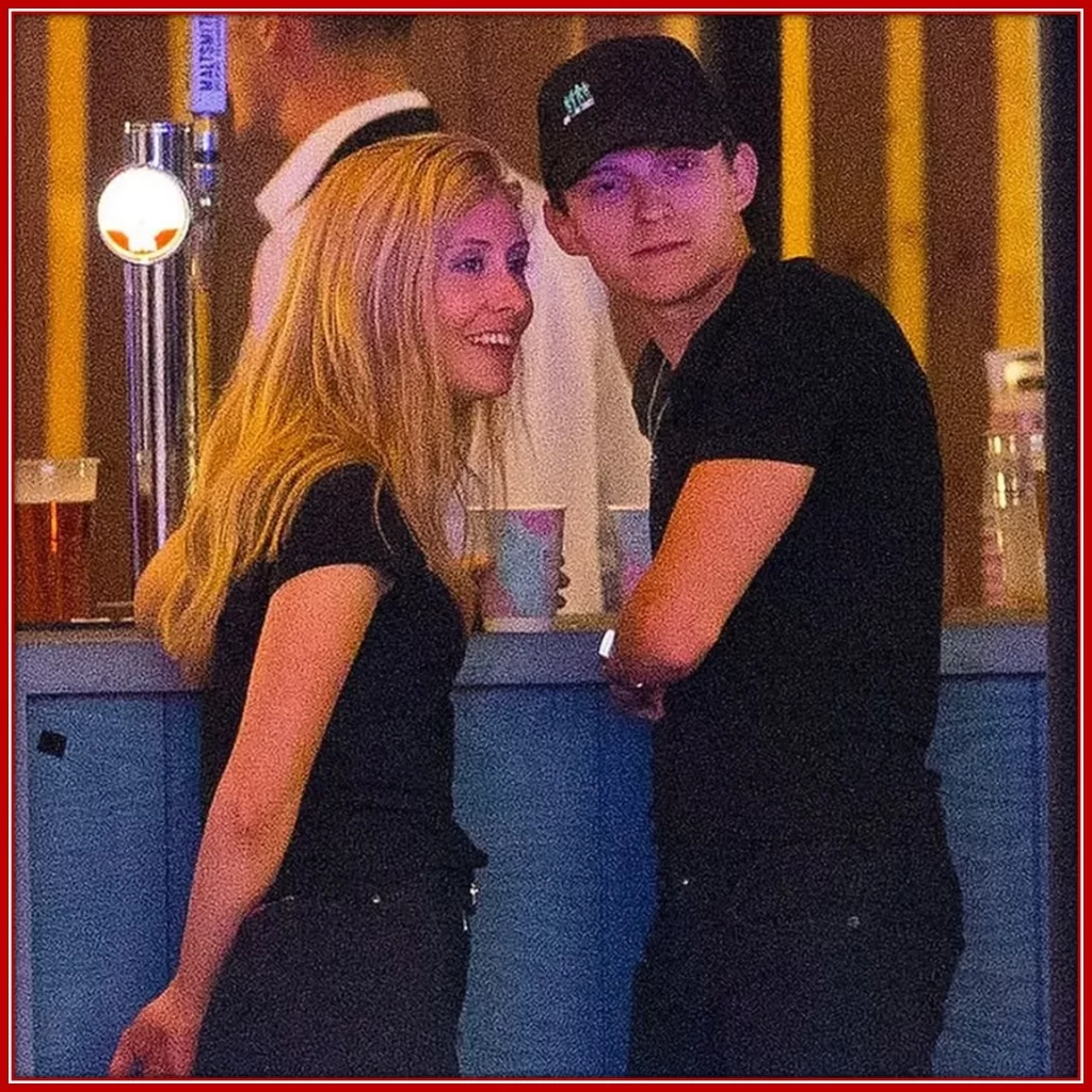 Tom Holland and Olivie are having a good time in the bar.