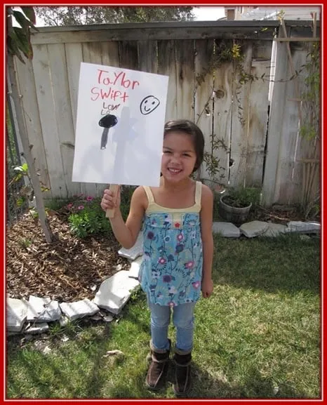 Behold Olivia Rodrigo Holding up a Placard to Express her Love for Singer Taylor Swift.