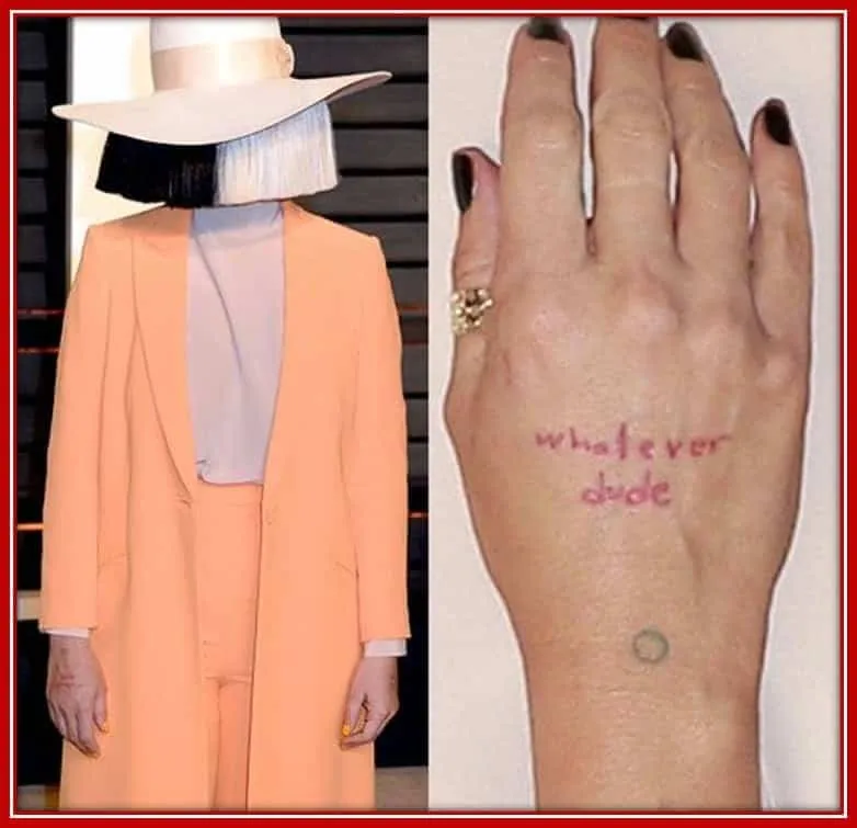 Sia Furler's Tattoo is the Word on the back of her Palm, "Whatever Dude"